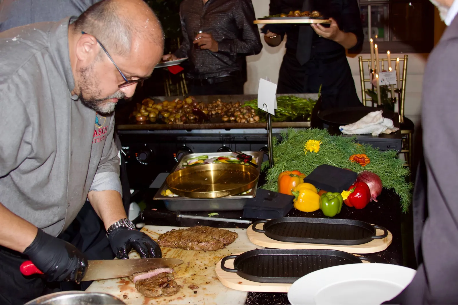 Rasoi Catering chef carving grilled steak to order at a live carving station